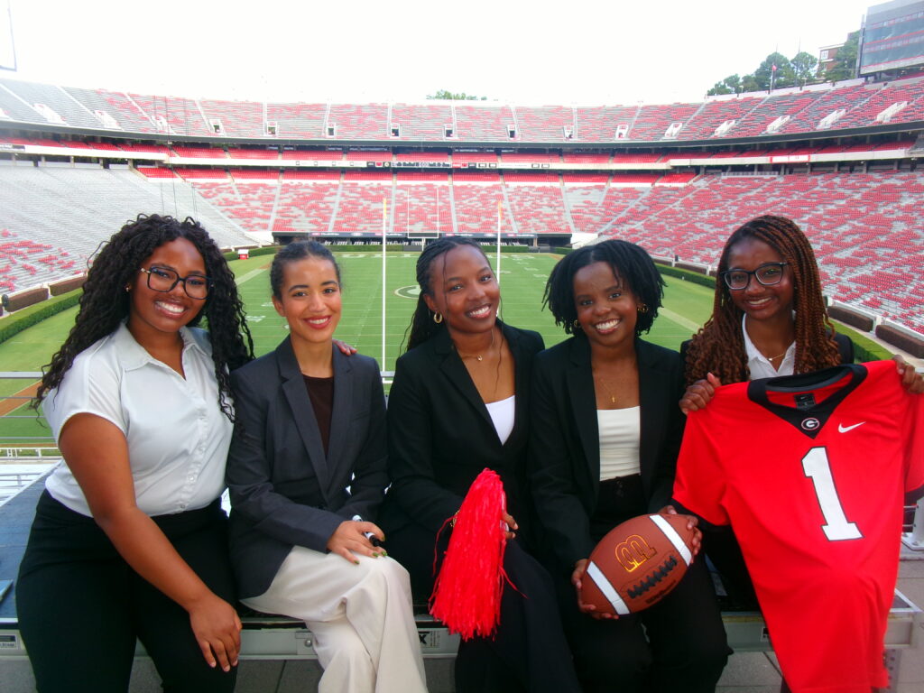 group of students in front of football field