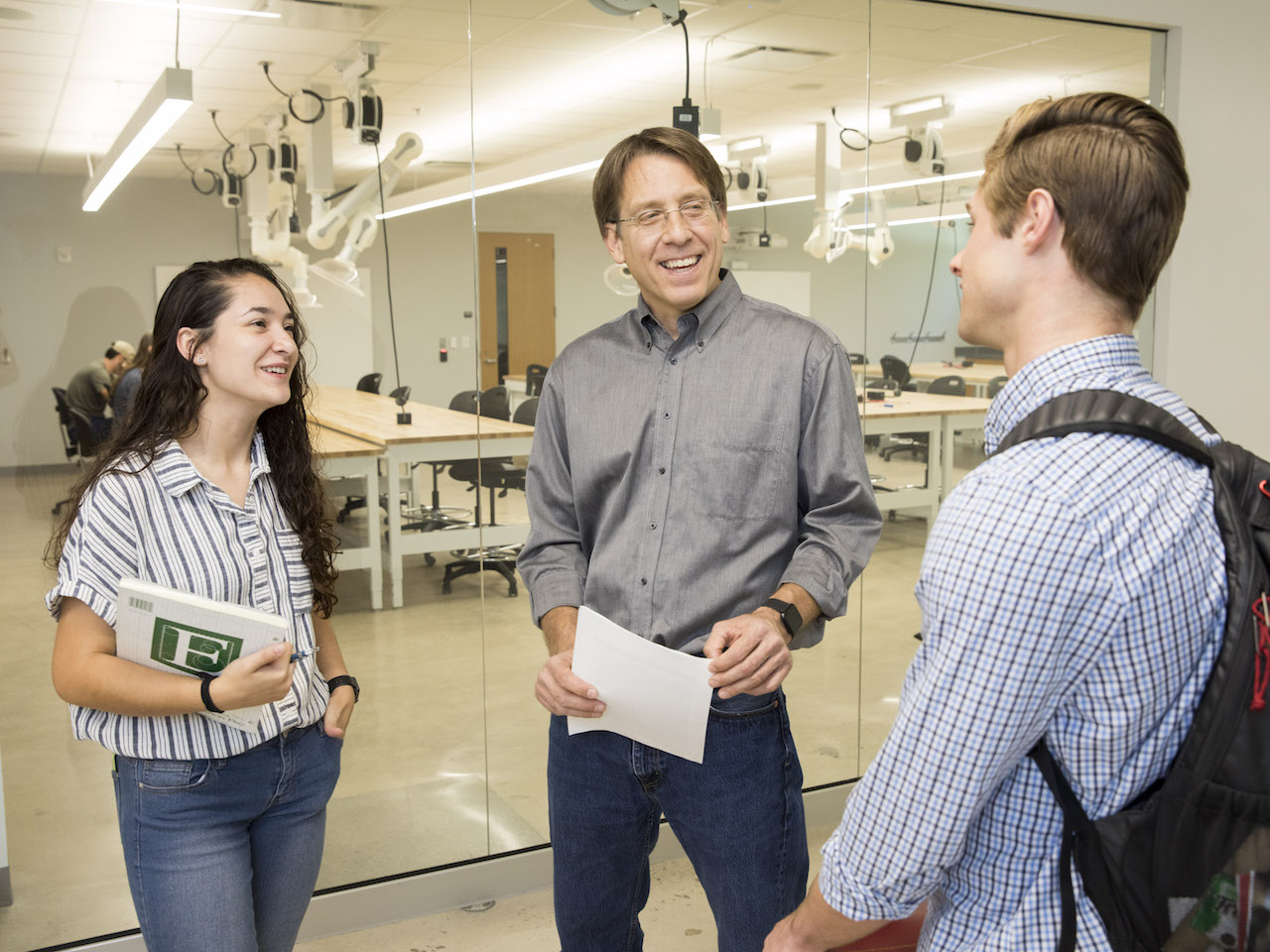 Professor talking to two students