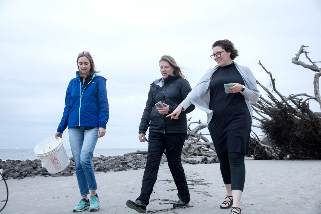 Emily Roberts, Jenna Jambeck and Jennie Mathis-Alexander collect litter debris on Jekyll Island’s Driftwood Beach.