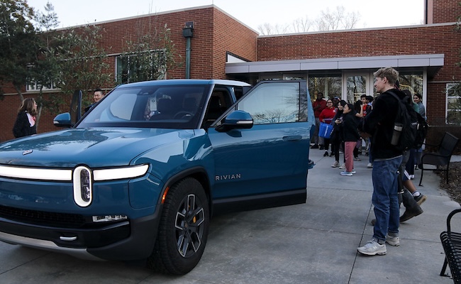 Rivian vehicle parked outside UGA Engineering building with students