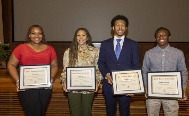 Four students holding Embracing Diversity Celebration scholarship