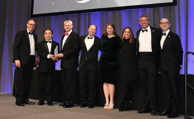 Group poses for photo on stage at Georgia Engineering Awards with award