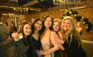 Engineering students including Frida Alvarado (second from left) gather for the Society of Women Engineers Semi-Formal. (Photo taken prior to COVID-19 safety restrictions.)