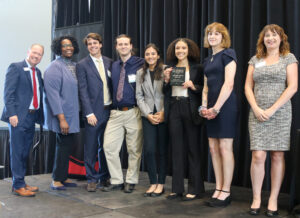 Students pose with award