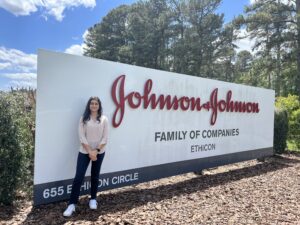 Anisha stands in front of Johnson + Johnson campus sign
