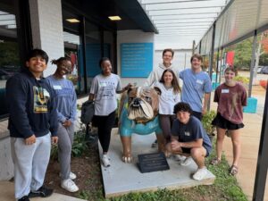 group of students posing with bulldog statue