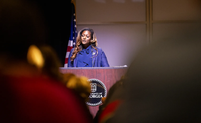 Adrienne Madison stands behind podium