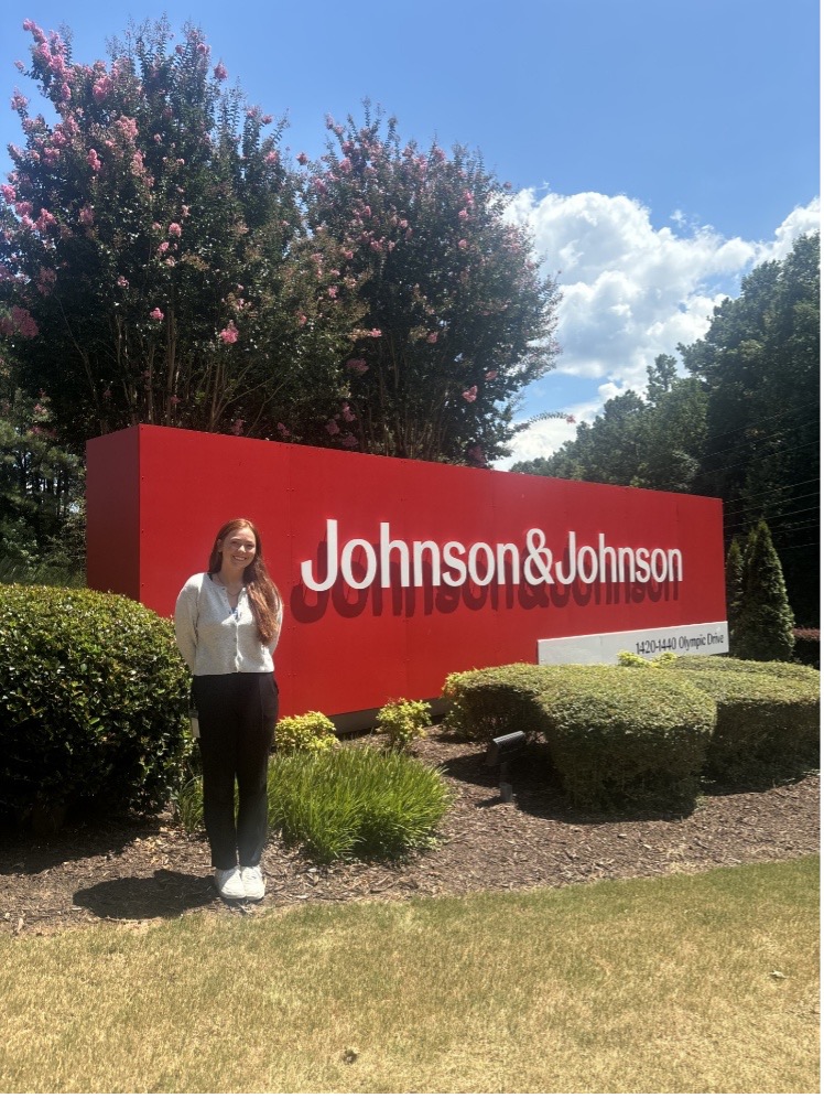 Emily standing in front of Johnson & Johnson sign