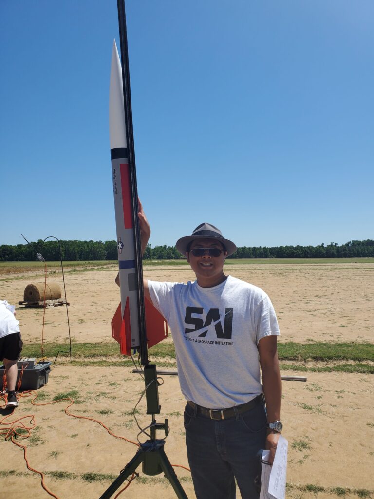 Sid Amonchomchupong prepares a rocket for launch at a National Association Rocketry certification event in South Carolina last spring.
