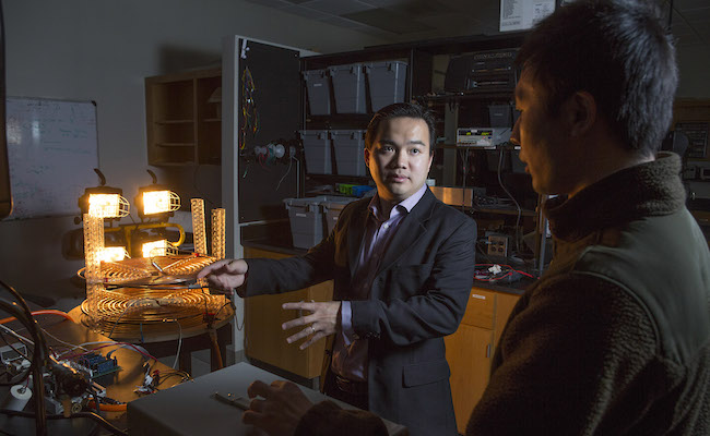 Professor Zion Tze discusses progress on a wireless power transfer station research project with Yabio Gao, a PhD student from China working on the project.