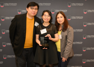 Victoria Lam holding award