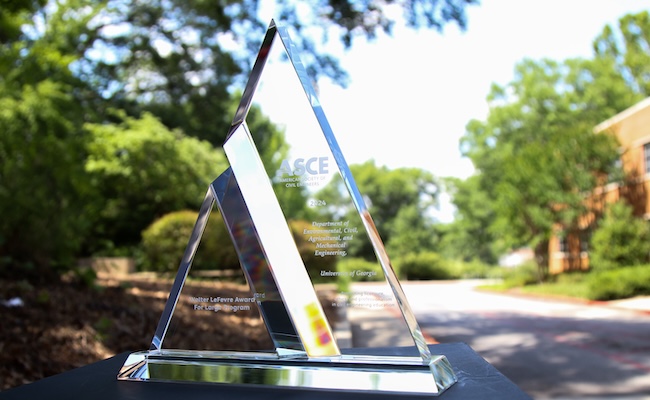 ASCE Award glass trophy in front of Driftmier Engineering Center