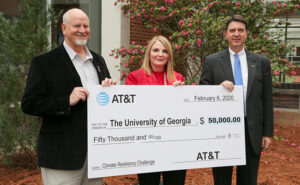Paul Chambers Jr, Jennifer Frum, and Mark Risse holding large check