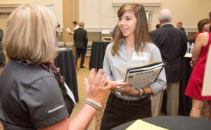 Student talks with employer at career fair