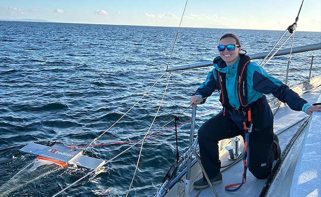 woman poses on sailboat