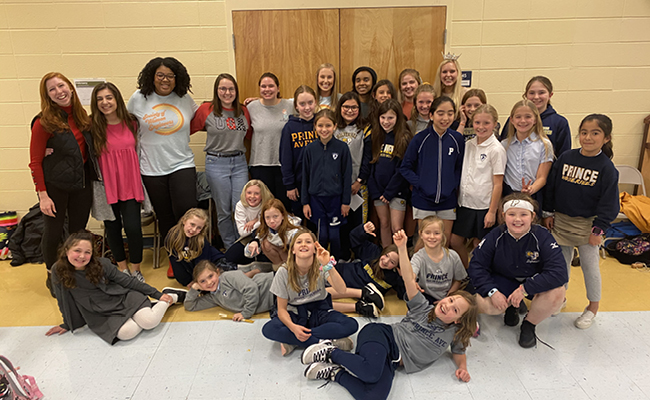 Mariko Shaw (back row, third from left) and other members of UGA's Society of Women Engineers chapter work with students interested in STEM fields at an Athens area elementary school.