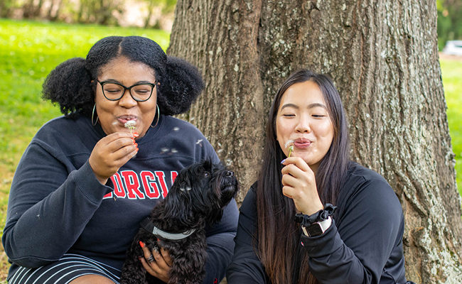 Mariko Shaw (left) and fellow engineering student Porsche Chen enjoy a spring day on the University of Georgia campus.
