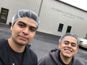Omar Ramos (right), who expects to graduate in Fall 2022, serves as a volunteer at the Foodbank of Northeast Georgia.