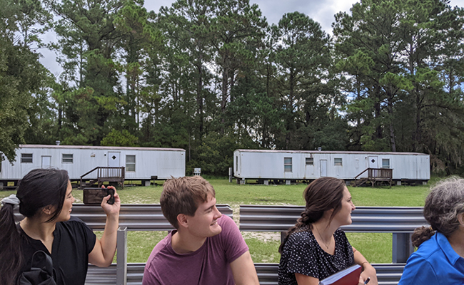 UGA Engineering students (L-R) Sophie Knoll, Alex Rush and Tannar Singer looking at trailers currently used to house visiting researchers.